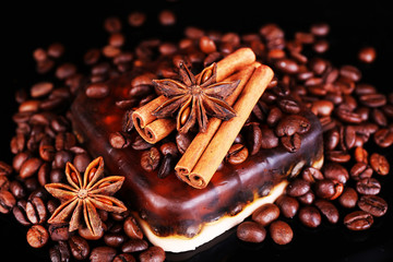 Organic soap with coffee beans and spices, on dark background