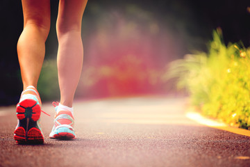 Fototapeta na wymiar young fitness woman legs runner running on trail
