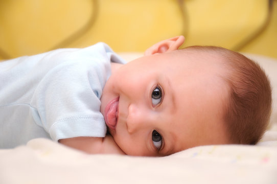 funny baby mocking on bed