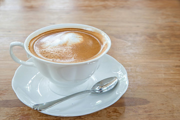 hot milk art coffee on wooden table