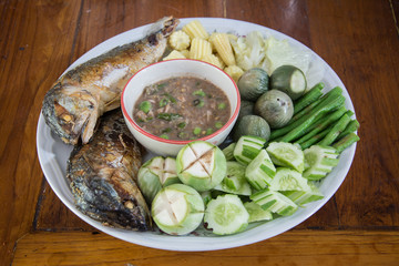 Shrimp paste with fried mackerel and vegetable on wood