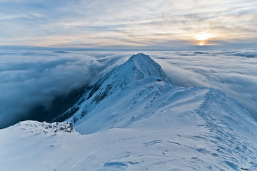 sunset over the mountains and clouds in winter