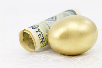 Yen and Gold Nest Egg on White Damask
