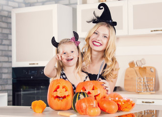 Kid on Halloween party making carved pumpkin with a little help 
