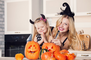 Kid on Halloween party making carved pumpkin with a little help 