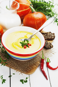 Spicy pumpkin soup with cream and chili pepper