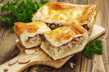 Pie with cabbage and sausages