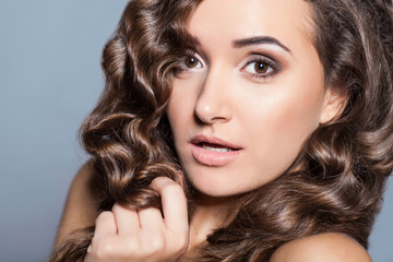 Portrait of a young brunette woman with beautiful hair