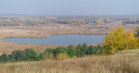 River landscape and an autumn wood