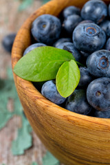 blueberry in a bowl on wooden surface