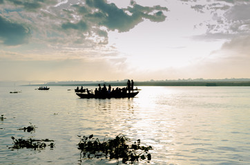 Fototapeta na wymiar boat sailors at sunrise sunset