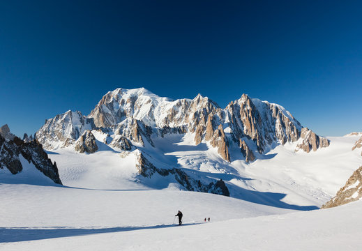 Ski mountaineers ascend the Vallee Blanche glacier. In backgroun