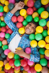 Cute boy smiling in ball pool