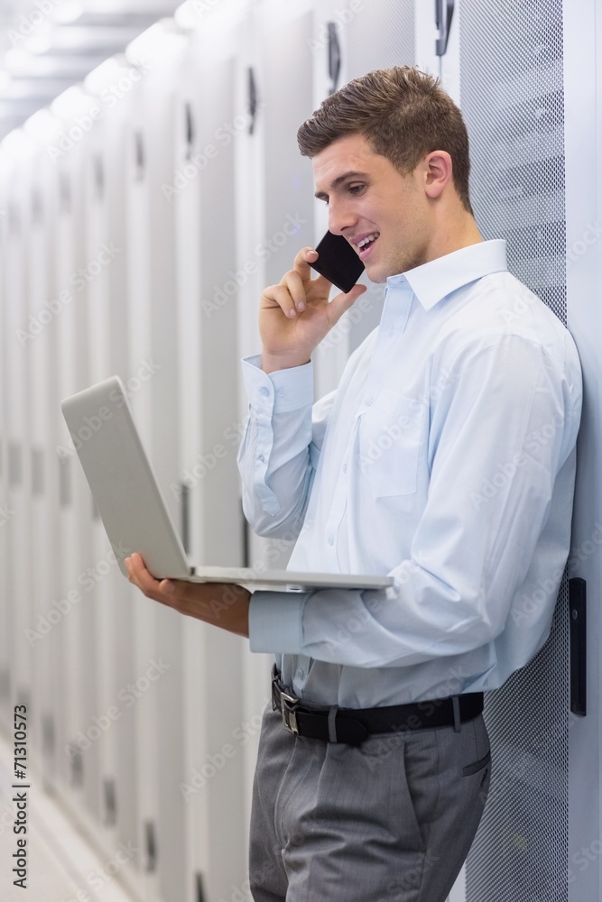 Aufkleber Smiling technician phoning and using his notebook