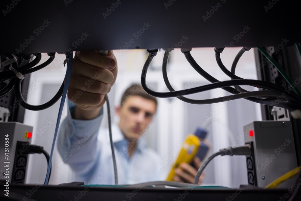 Aufkleber Technician using cable tester while fixing server