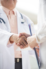 Close up  photo Asian medical team of doctors shaking hands insi