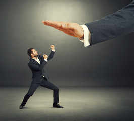 businessman and big palm in the dark studio
