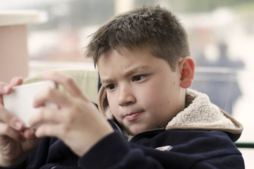 Boy kid child playing with mobile phone