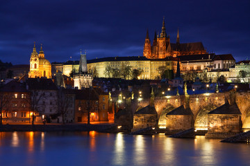 Night view of Charles Bridge and cathedral in Prague.