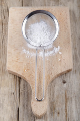 powdered sugar in a stainless steel colander