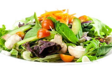 Plate of vegetable salad on white