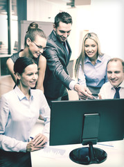 business team with monitor having discussion