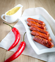 Roasted sausages with mustard sauce