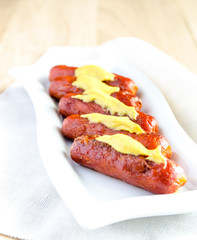 Roasted sausages with mustard sauce