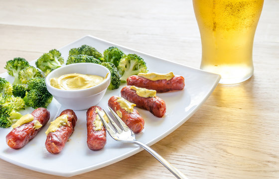 Roasted sausages with mustard sauce