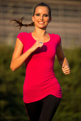 Preety young woman running on a track