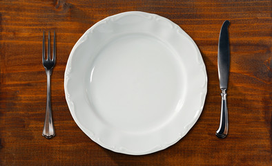 Empty Plate on Wooden Table with Cutlery