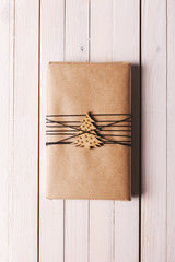 Christmas handcraft gift box on wood background.