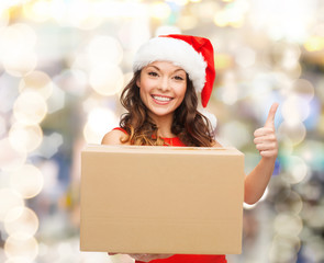 smiling woman in santa helper hat with parcel box