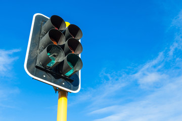 The traffic lights and little cobweb against blue sky background