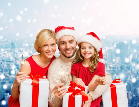 happy family in santa helper hats with gift boxes