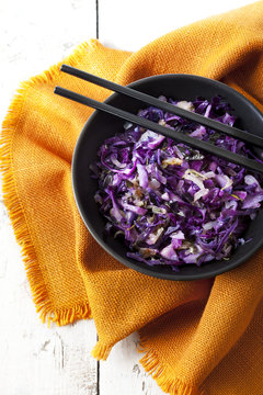sauteed purple cabbage on bowl with japanese chopsticks