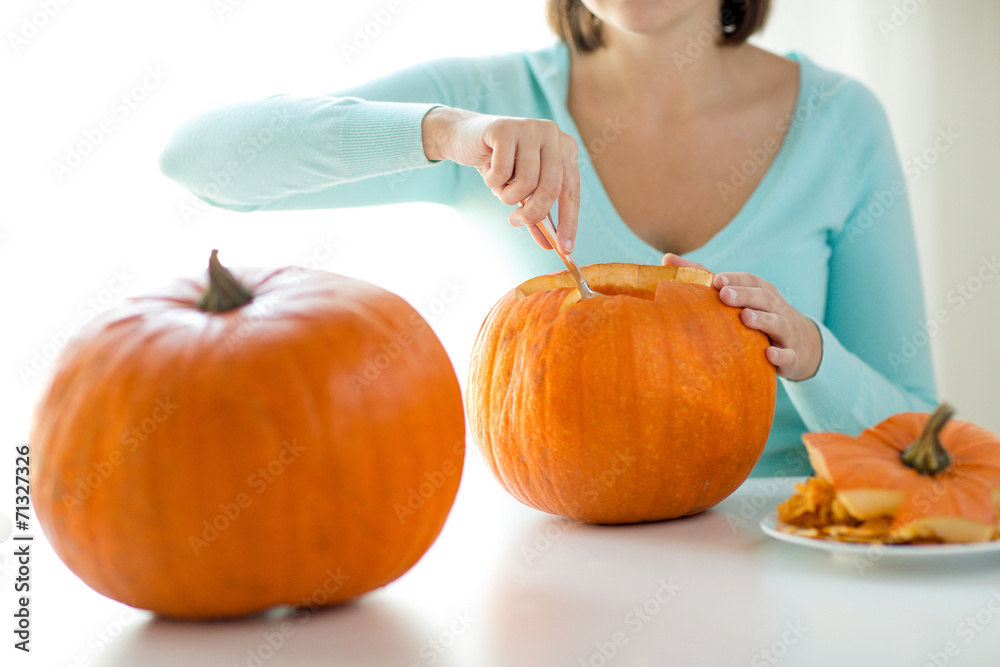 Wall mural close up of woman with pumpkins at home