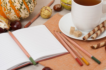 Opened Notebook. Cup Of Hot Tea With Sweets. Natural Linen Table