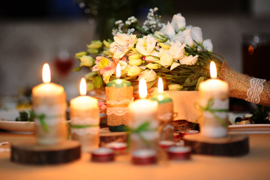 Wedding bouquet on a table with candles. Wedding in style "rusti