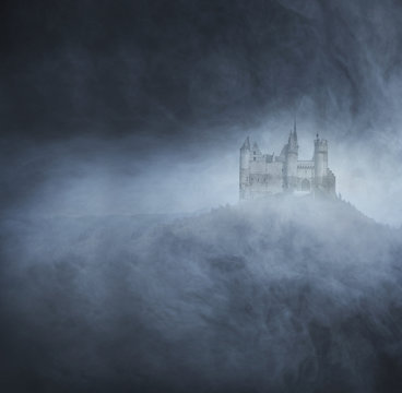 An old castle on a dark and foggy background