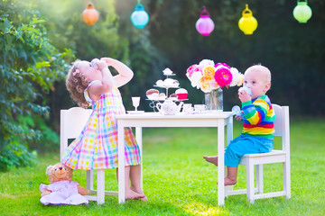Funny children at doll tea party