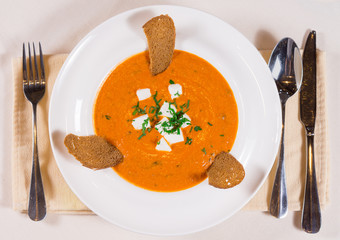 Delicious pumpkin or butternut soup with cheese