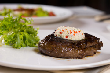 Steak Topped with Herbed Butter on Plate