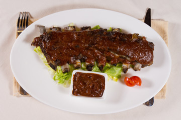 Overhead of Pork Ribs and Dipping Sauce on Plate