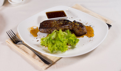 Steak on Plate with Garnish at Place Setting