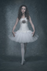 Ballet fashion style brunette woman. Wearing white corset and dr