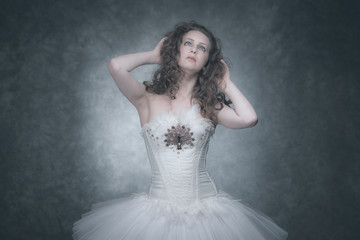 Ballet fashion style brunette woman. Wearing white corset and dr