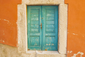 Fototapeta na wymiar Closed turquoise wooden door. Croatia.