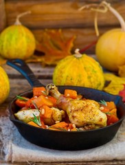 the baked chicken with pumpkin in a pig-iron frying pan