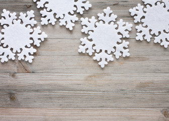 Snowflakes on old wood - background
